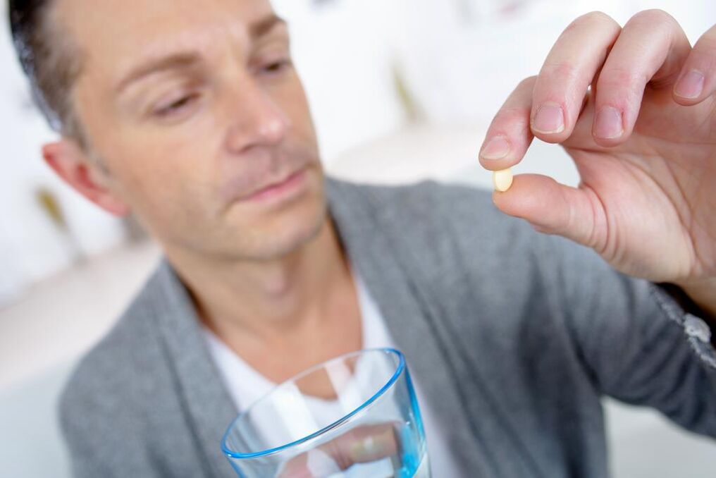 a man drinks a potency-boosting pill